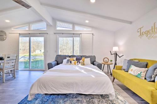 a bedroom with a bed and a couch at Game Room and Lake Access Serene Tobyhanna Retreat in Tobyhanna