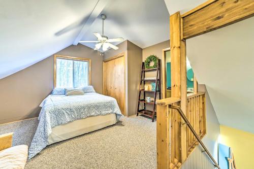 a bedroom with a bed and a ceiling fan at Higgins Lake Retreat - Hike, Swim, Relax! in Roscommon