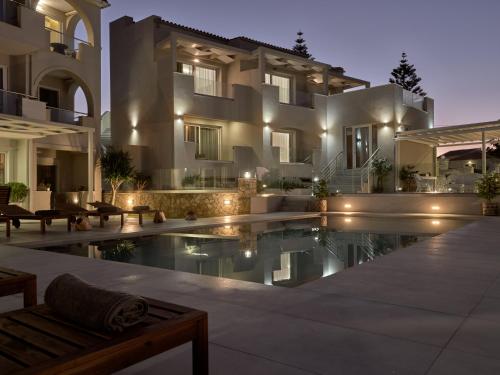 a villa with a swimming pool at night at Stefania Apartments in Kipseli