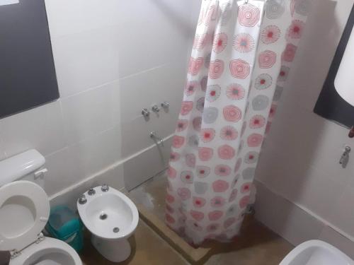 a bathroom with a toilet and a shower curtain at Don Marcos - Las Estancias de Aconquija in Cochuna