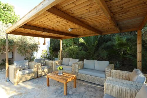 a pavilion with couches and a table on a patio at Listaros Villas in Lístaros