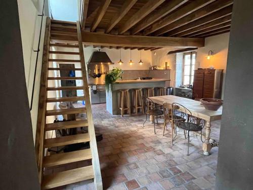 a kitchen and dining room with a table and chairs at Maison de Campagne in Beautiful Burgundy in Noyers-sur-Serein