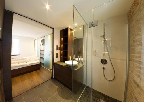a bathroom with a glass shower and a sink at Ringelnatz Warnemünde in Warnemünde