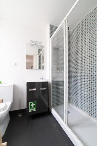 a bathroom with a shower and a toilet and a sink at Ourique Charm Apartments in Lisbon