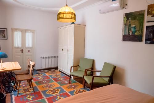 a room with two chairs and a table and a table at Old Radio hostel in Samarkand