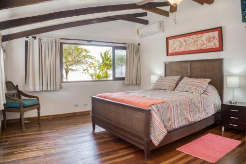 a bedroom with a large bed and a window at Casa La Palapa in Esparza