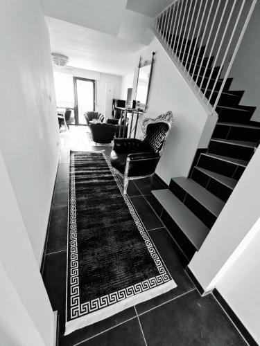 a living room with a staircase with a rug at Roggendorf Zimmervermietung in Roggendorf
