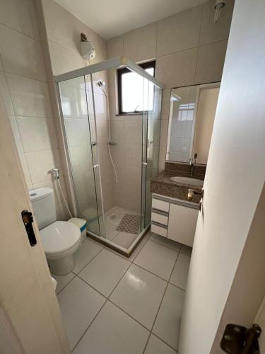 a bathroom with a shower and a toilet and a sink at Apartamento em Arraial do Cabo 501 in Arraial do Cabo
