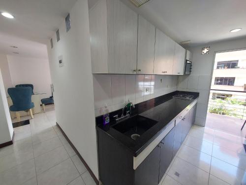 a kitchen with a sink and a counter top at Apartamento Laureles la 33 in Medellín