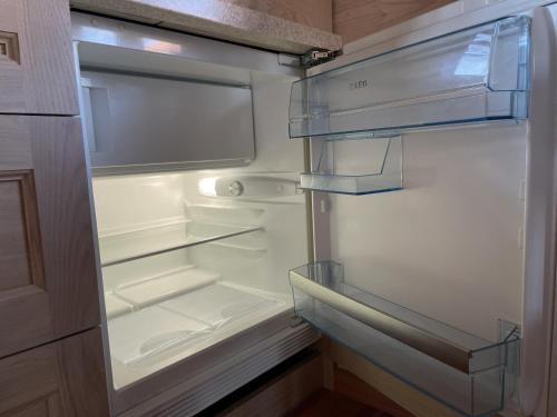 an empty refrigerator with its door open at Dore in Lielvārde