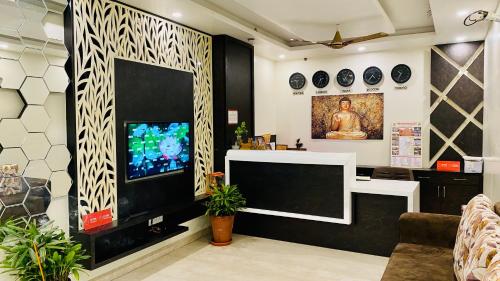 a living room with a large screen tv in a room at Hotel Pulse Inn Jaipur in Jaipur