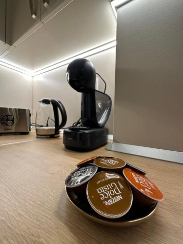 a black coffee pot sitting on top of a table at Rosco Apartment Transalpina in Alba Iulia