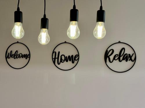 a group of light bulbs with the words relax home at Rosco Apartment Transalpina in Alba Iulia