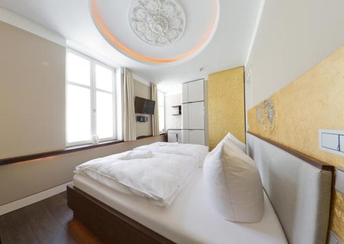 a bedroom with a white bed and a large window at Ringelnatz Warnemünde in Warnemünde