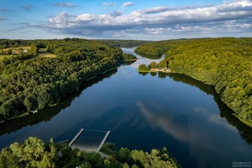 an aerial view of a lake with a dock in the middle at Kaszuby Punkt Klonowo Przywidz sauna klima basen in Przywidz