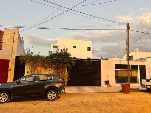 a small car parked in front of a building at Departamento en Altabrisa Merida in Mérida