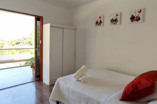 um quarto branco com uma cama e uma grande janela em Hermosa casa de campo vacacional La Estancia de Lunahuaná em Lunahuaná