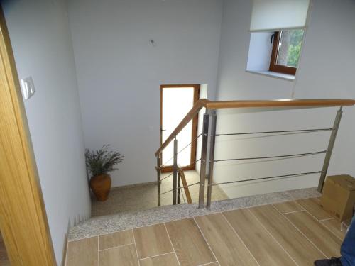 a staircase in a house with a wooden railing at Quinta do Cadaval in Cortiçô