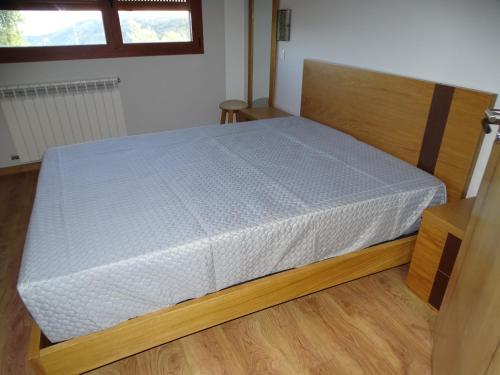 a bedroom with a bed with a white mattress at Quinta do Cadaval in Cortiçô