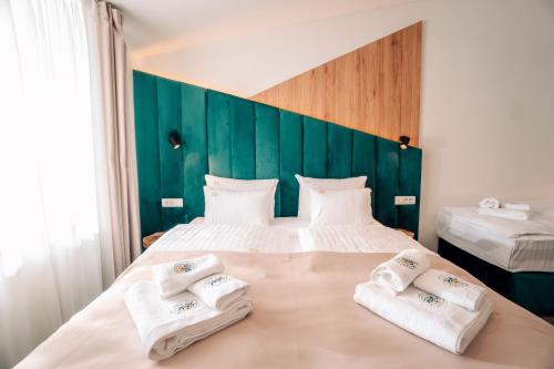 a hotel room with a bed with towels on it at Hotel Forest in Pale