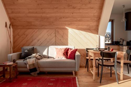 a living room with a couch and a table at TATRA REST in Kościelisko