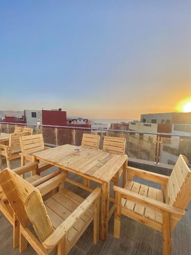 a wooden table and chairs on top of a roof at Ayour Beach House 5 in Imsouane