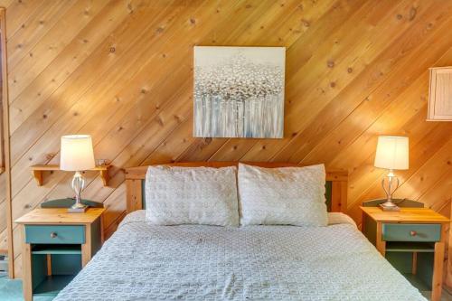 a bedroom with a bed with two lamps on tables at Rustic Roost Cabin in Vega