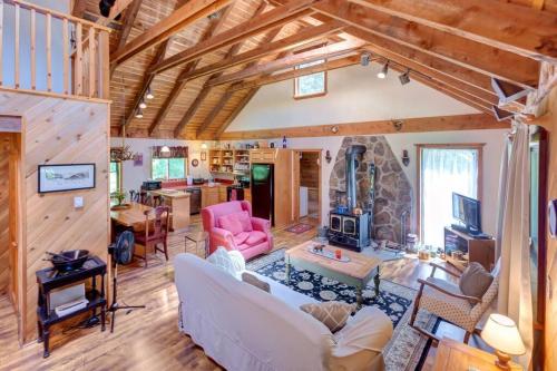 a large living room with a stone wall at Rustic Roost Cabin in Vega
