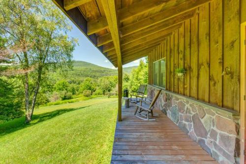 a porch of a wooden house with a bench on it at Rustic Roost Cabin in Vega