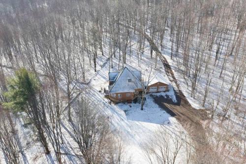 an aerial view of a house in the snow at Catskills Enchanted Forest in Bloomville