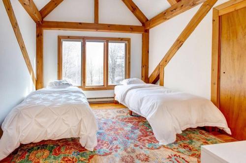 a room with three beds in a attic at Catskills Enchanted Forest in Bloomville