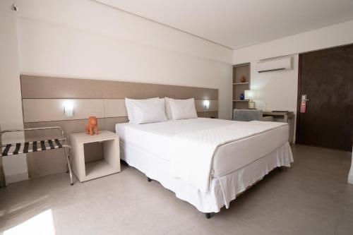 a bedroom with a large white bed in a room at Hotel Cabo Branco Atlântico in João Pessoa