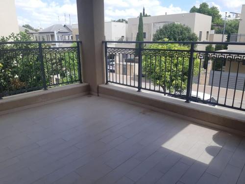 a balcony with a fence and a view of a street at Adorable 3 bedroom Brenner "Hill" suite in Giv‘at Brenner