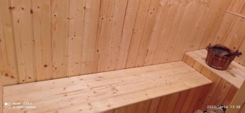 a wooden paneled sauna with a bench in it at Kaszuby Punkt Klonowo Przywidz sauna klima basen in Przywidz