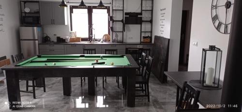 a kitchen with a pool table in the middle of it at Kaszuby Punkt Klonowo Przywidz sauna klima basen in Przywidz
