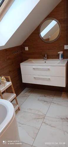 a bathroom with a sink and a mirror at Kaszuby Punkt Klonowo Przywidz sauna klima basen in Przywidz