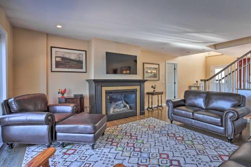a living room with leather furniture and a fireplace at Beautiful Lakefront Retreat with Deck and Views! in Newton