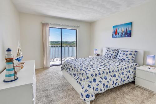 a bedroom with a bed and a large window at Bayshore Yacht & Tennis 314 in Clearwater Beach
