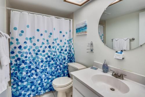 a bathroom with a toilet and a sink and a mirror at Bayshore Yacht & Tennis 314 in Clearwater Beach