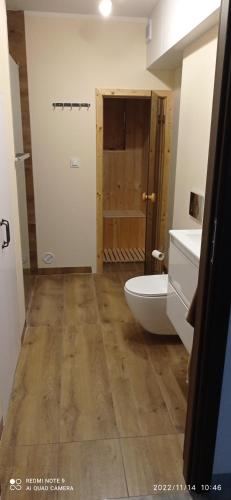 a bathroom with a tub and a toilet and a sink at Kaszuby Punkt Klonowo Przywidz sauna klima basen in Przywidz