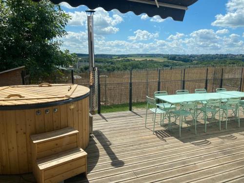 a wooden deck with a table and chairs on it at Little Farm Comfort&PrestigeHouse in Ittre