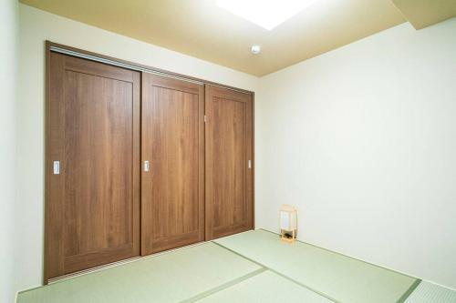 a empty room with wooden cabinets and a lamp at 朝ドラのロケ地 信楽焼きの窯元に泊まれます 無料駐車場有 4人まで宿泊可能 in Nagano