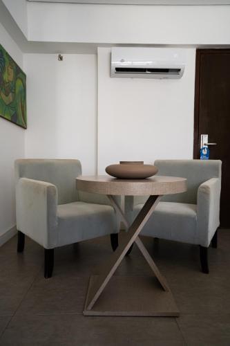a table and two chairs in a room at Hotel Cabo Branco Atlântico in João Pessoa