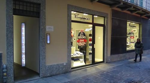 a woman walking in front of a store window at Residence SANTABBONDIO in Como
