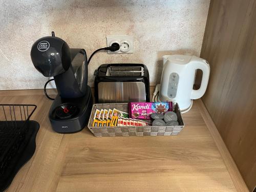 a basket of food sitting next to a coffee maker at Roosevelt Apartment in Skopje