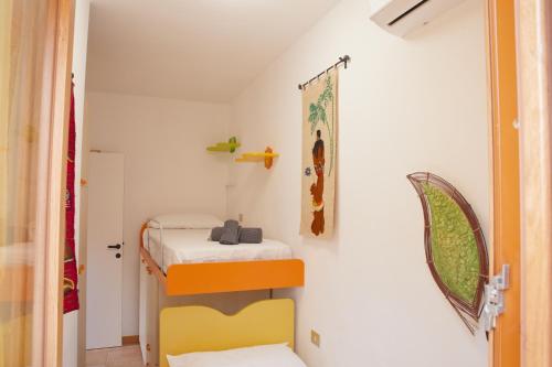a small room with two bunk beds in it at Conero - Patio Privato e Parcheggio by Host Hero in Marcelli