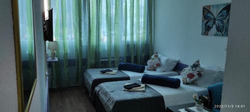 a hotel room with two beds and a couch at Bed and Breakfast M Jasmin in Sarajevo