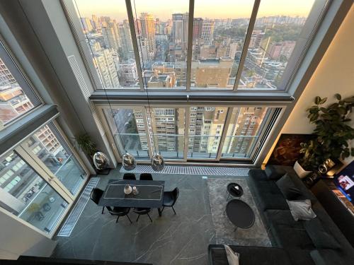 a room with a table and chairs in a building with windows at The Penthouse Kyiv in Kyiv