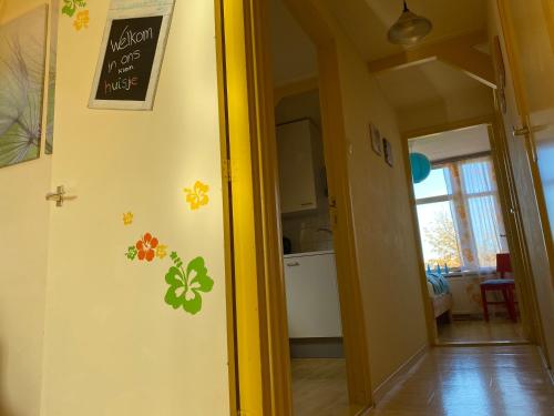 a kitchen with a door with flowers on the wall at Zierikzee Appartement ZZ 41 at the Waterfront in Zierikzee