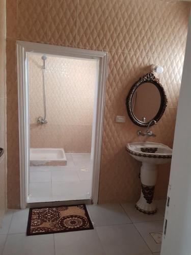 a bathroom with a shower and a sink and a mirror at Ibbin hospitality house in Ajloun